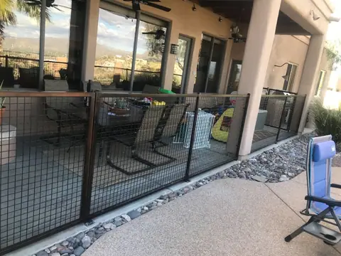 Steel railing with wire mesh panels around a covered patio with a valley view