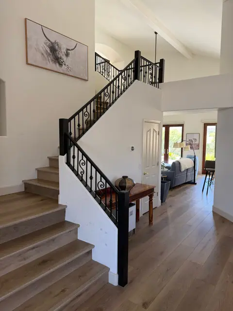Black steel stair railing in a two story entry