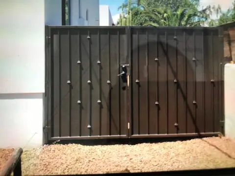 Brown double gate with vertical bars, collars and a center latch