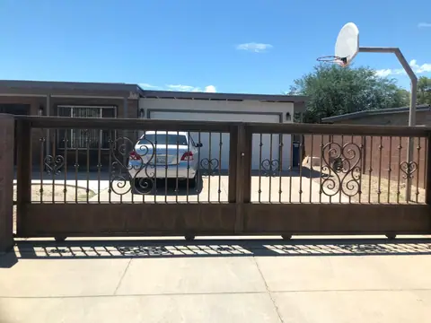 Rolling drive gate with heart scroll panels in a bronze finish