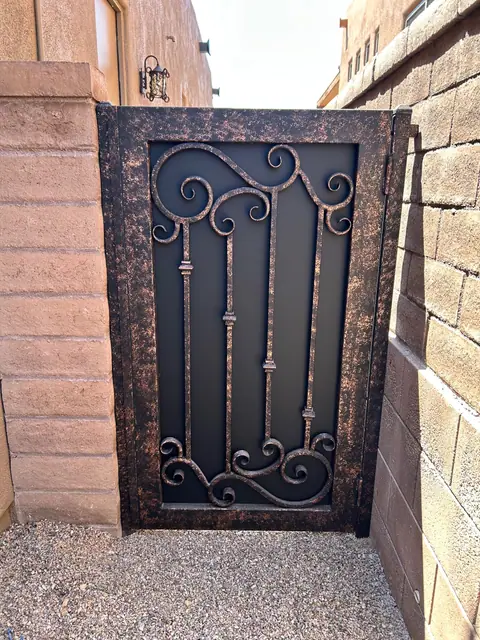Walk gate with scrollwork in a copper vein finish between block walls