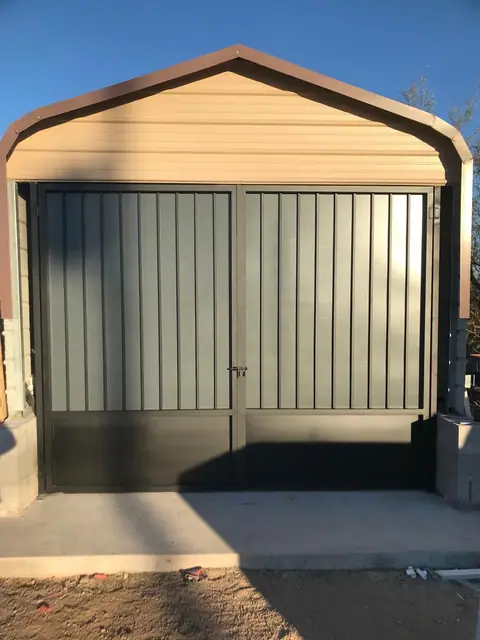 Double steel gates closing in the front of a metal carport